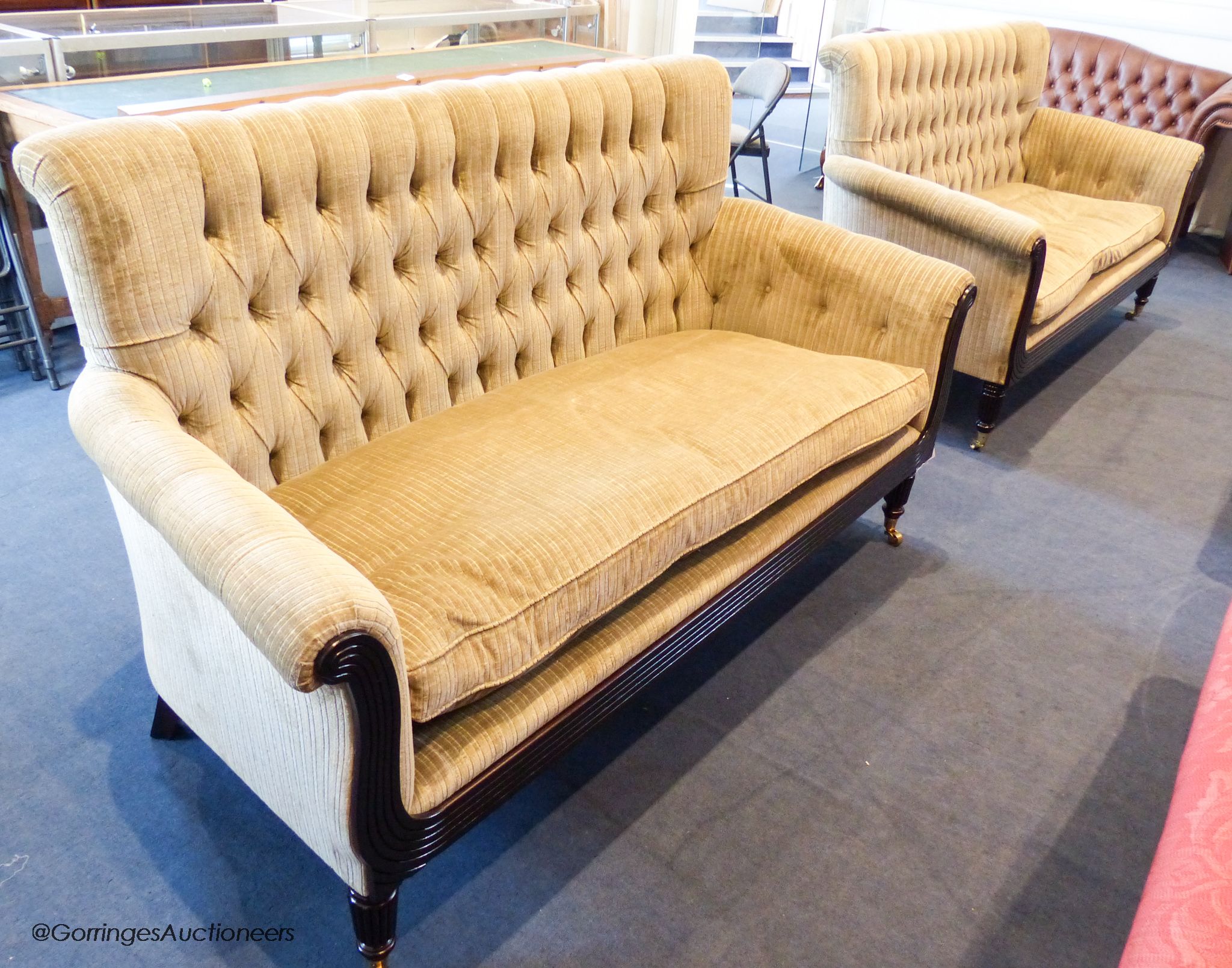 A pair of George IV style mahogany button back sofas, 181 cm wide